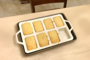 Tray of mini lemon loaves in a white silicone baking pan